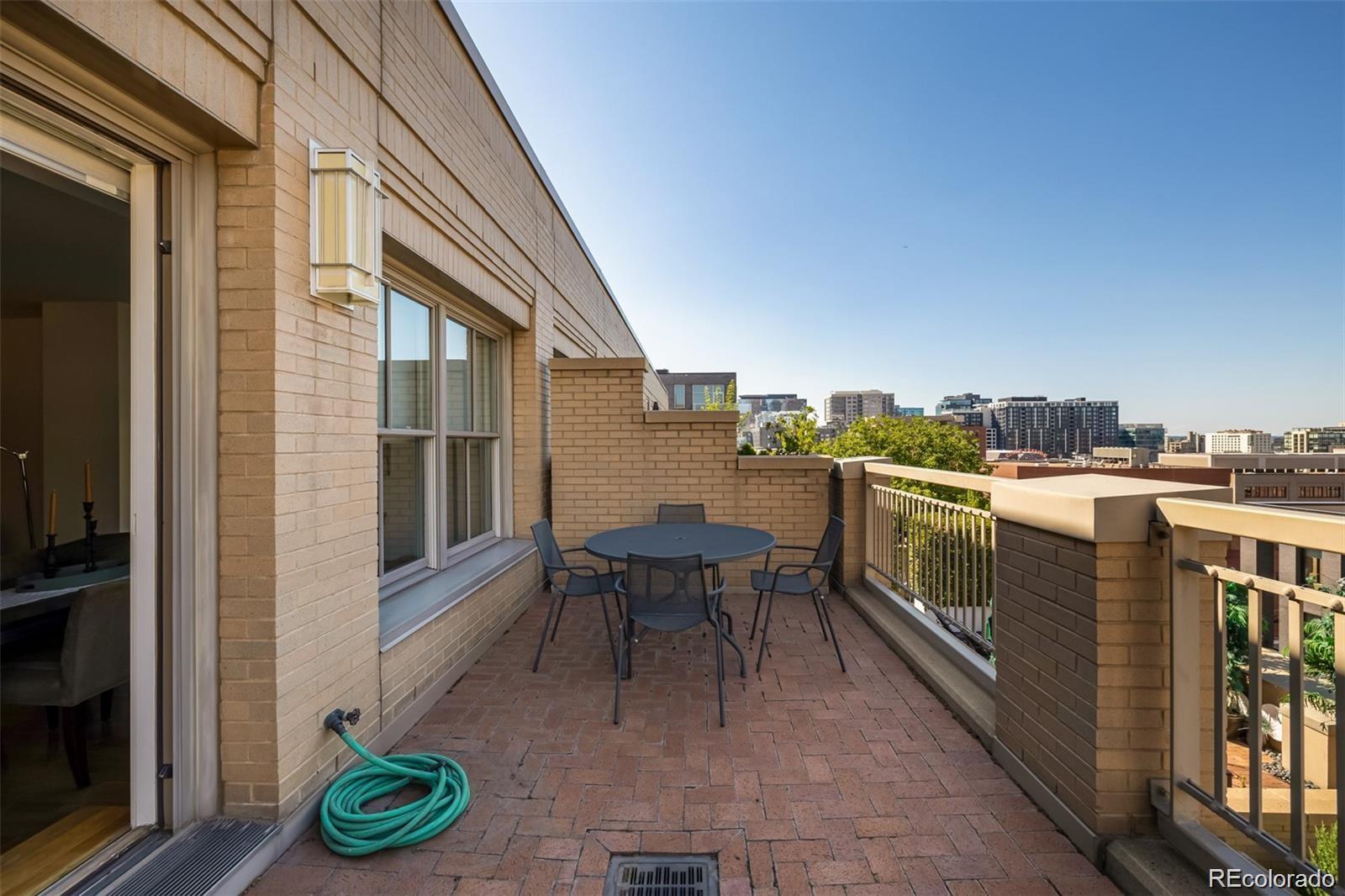 1560 Blake Street, Unit 810 Denver, CO 80202 - Photo 40 of 48 a balcony with a table and chairs
