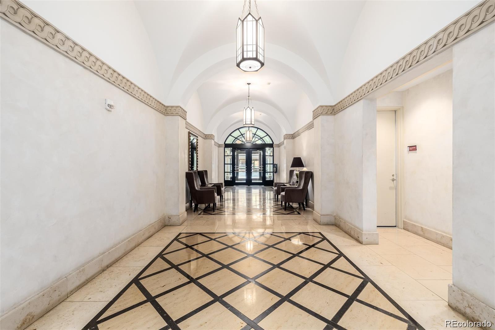 1560 Blake Street, Unit 810 Denver, CO 80202 - Photo 43 of 48 a view of a hall way with furniture and chandelier