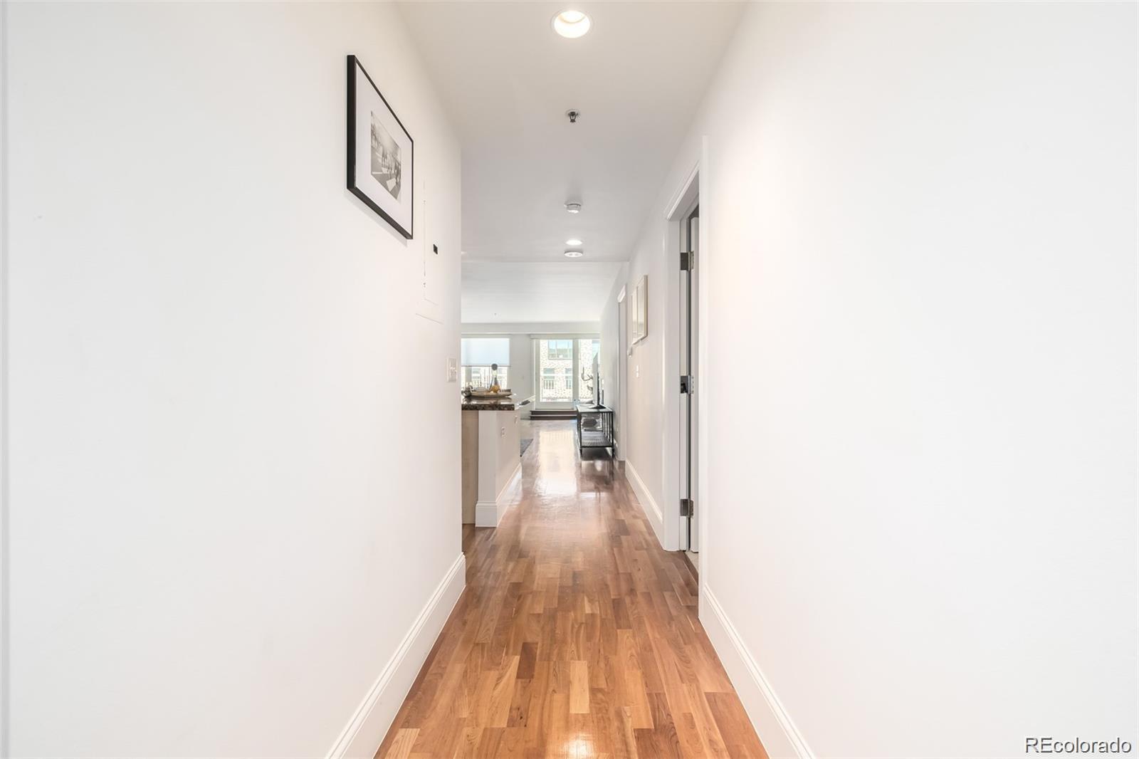 1560 Blake Street, Unit 810 Denver, CO 80202 - Photo 8 of 48 a view of a hallway with wooden floor
