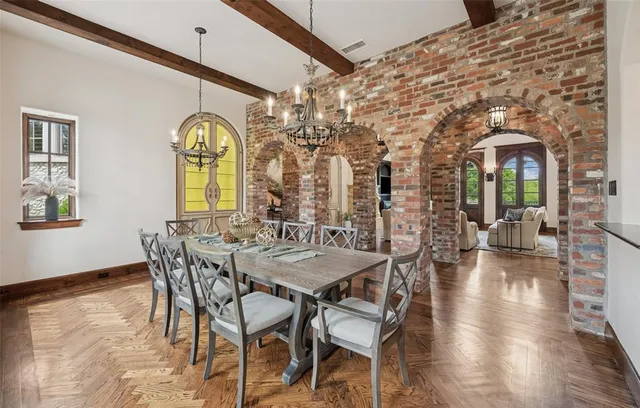 a view of a dining room with furniture and a chandelier