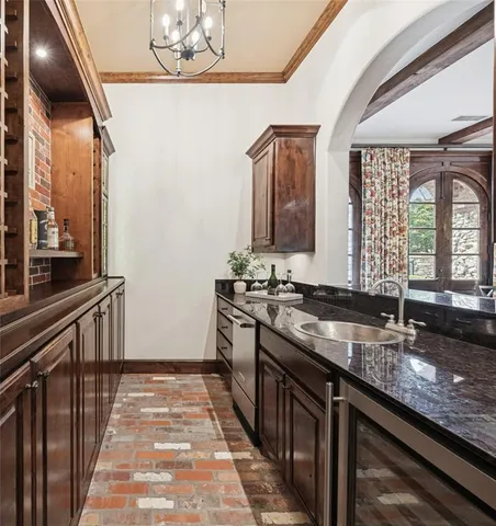 a kitchen with stainless steel appliances granite countertop a sink and a stove