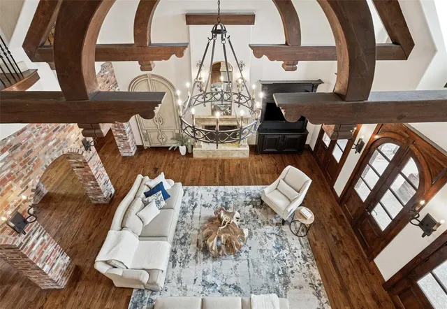 a view of a living room with furniture and wooden floor