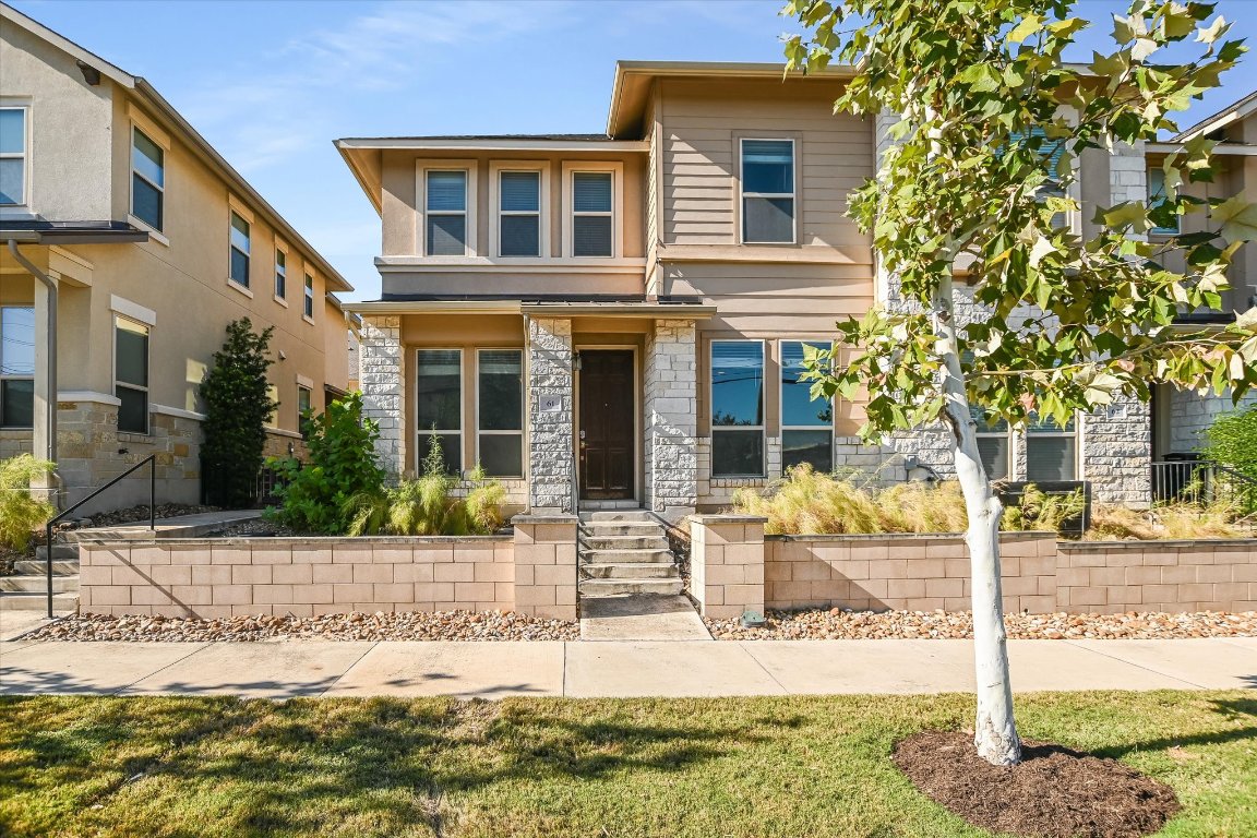 a front view of a house with garden