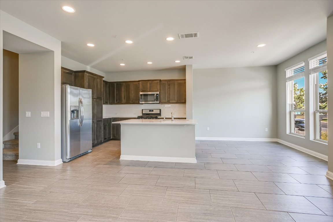6814 East Riverside Drive, Unit 61 Austin, TX 78741 - Photo 10 of 10 a view of kitchen with kitchen island granite countertop a refrigerator and a sink