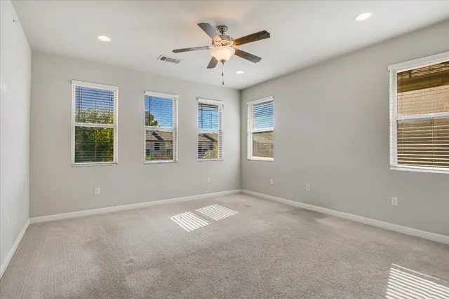a view of kitchen with stainless steel appliances granite countertop a stove and a refrigerator