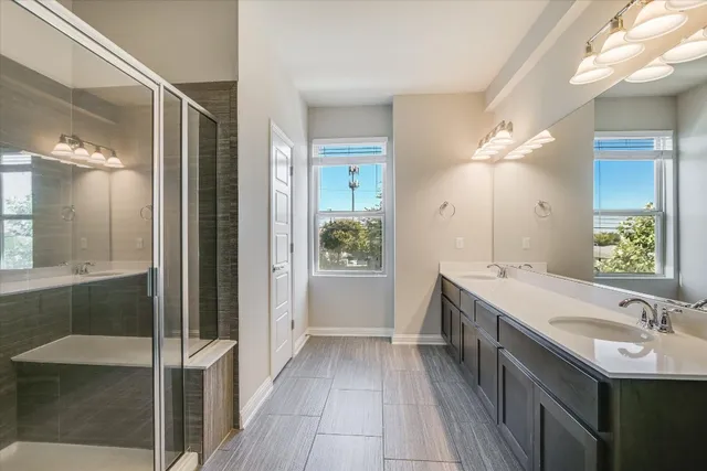 a view of kitchen with kitchen island granite countertop a refrigerator and a sink