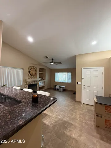a living room with furniture a fireplace and a window