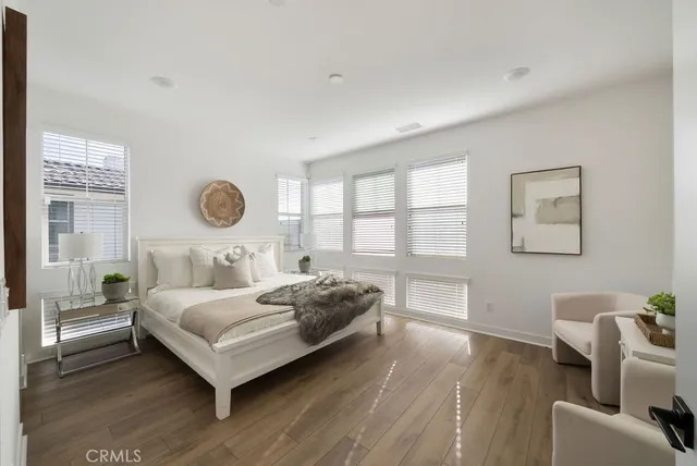 a bedroom with a bed and a large window