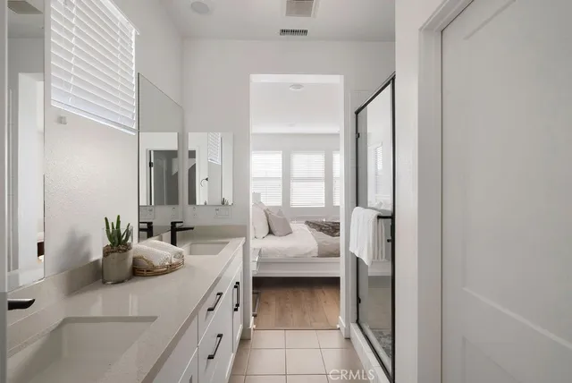 a en suite bathroom with a double vanity sink and shower