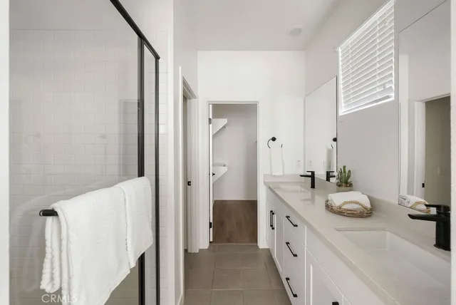 a bathroom with a double vanity sink and mirror