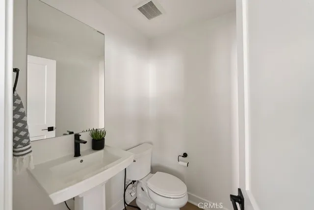 a bathroom with a sink toilet and mirror