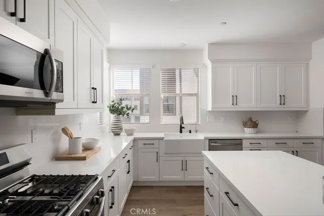a kitchen with a sink stove top oven and cabinets