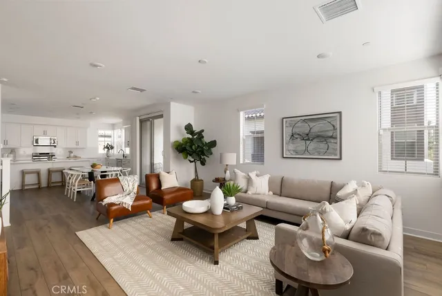 a living room with furniture kitchen and a window