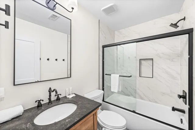 a bedroom with a bed and a view of bathroom