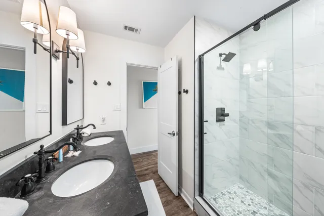 a bathroom with a shower and a glass door