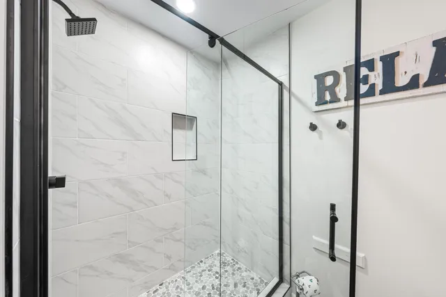 a bathroom with a glass shower door