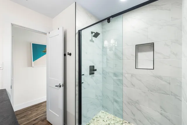 a bathroom with a granite countertop sink a toilet and a mirror