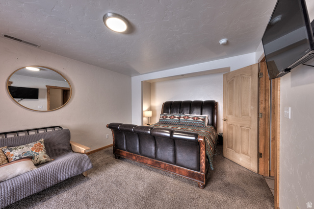 3461 Westwater Road, Unit 6 Moab, UT 84532 - Photo 15 of 33 Carpeted bedroom with a textured ceiling and baseboards