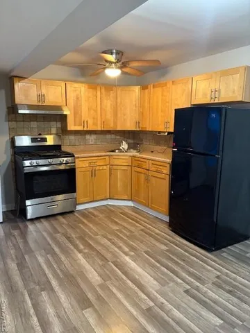 a kitchen with stainless steel appliances a stove a sink and a refrigerator