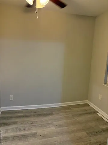 a view of a room with wooden floor