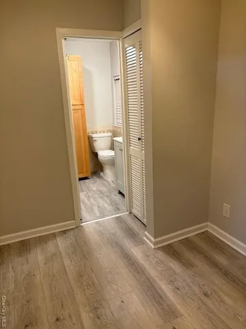 a view of a bathroom with wooden floor and a sink