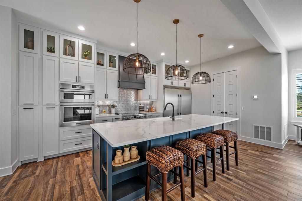4509 Peach Tree Lane Kingston, OK 73439 - Photo 35 of 39 a large kitchen with a table and chairs
