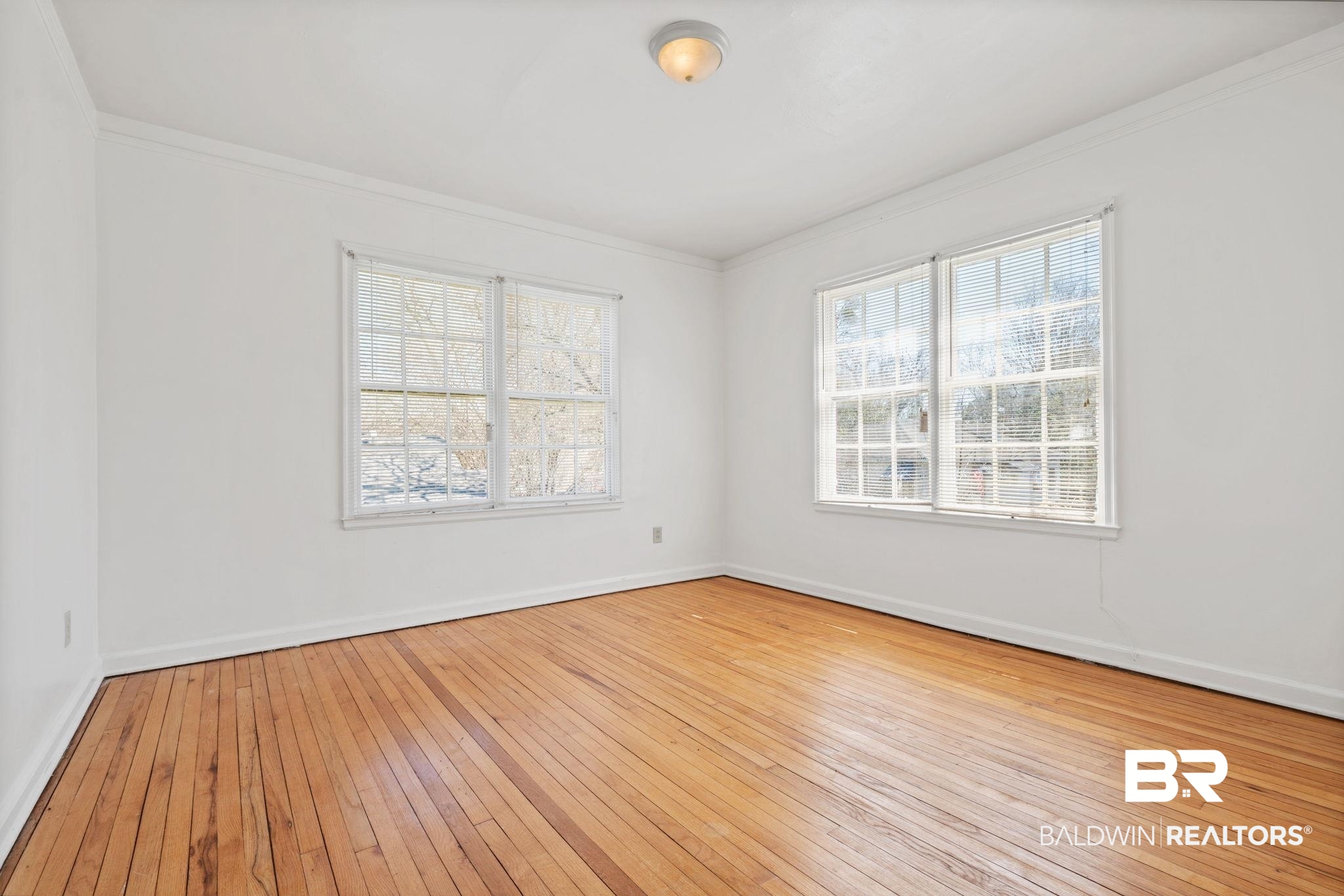 1707 Church Street Mobile, AL 36604 - Photo 31 of 43 Spare room with baseboards, crown molding, and hardwood / wood-style flooring