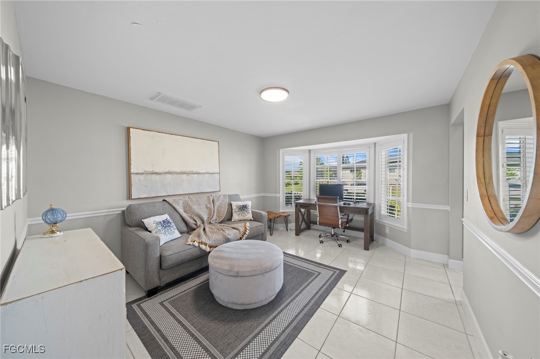 5303 Southwest 26th Court Cape Coral, FL 33914 - Photo 13 of 45 a living room with furniture and a large window