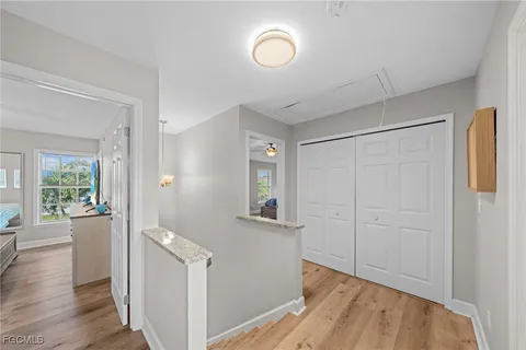 a view of a room with wooden floor and windows