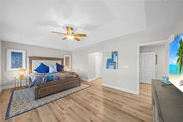 a bedroom with a large bed and a chandelier