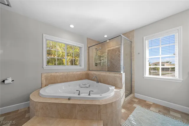 a bath tub sitting in a bathroom next to a window