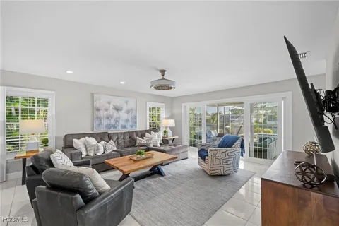 a living room with furniture and large windows