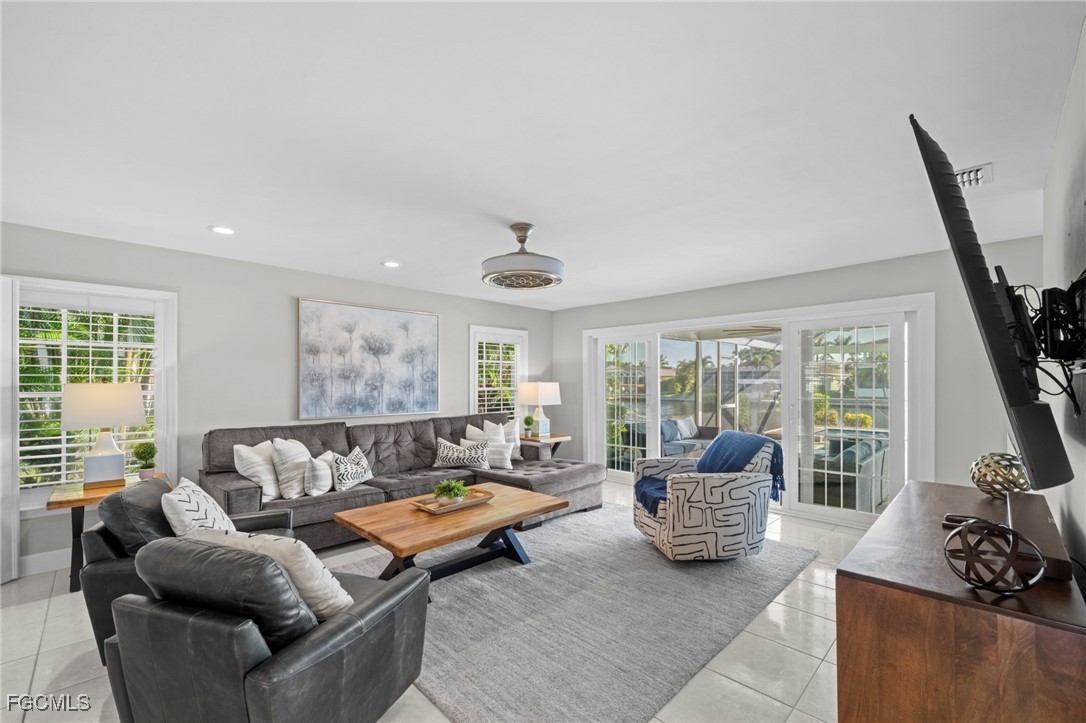 5303 Southwest 26th Court Cape Coral, FL 33914 - Photo 2 of 45 a living room with furniture and large windows