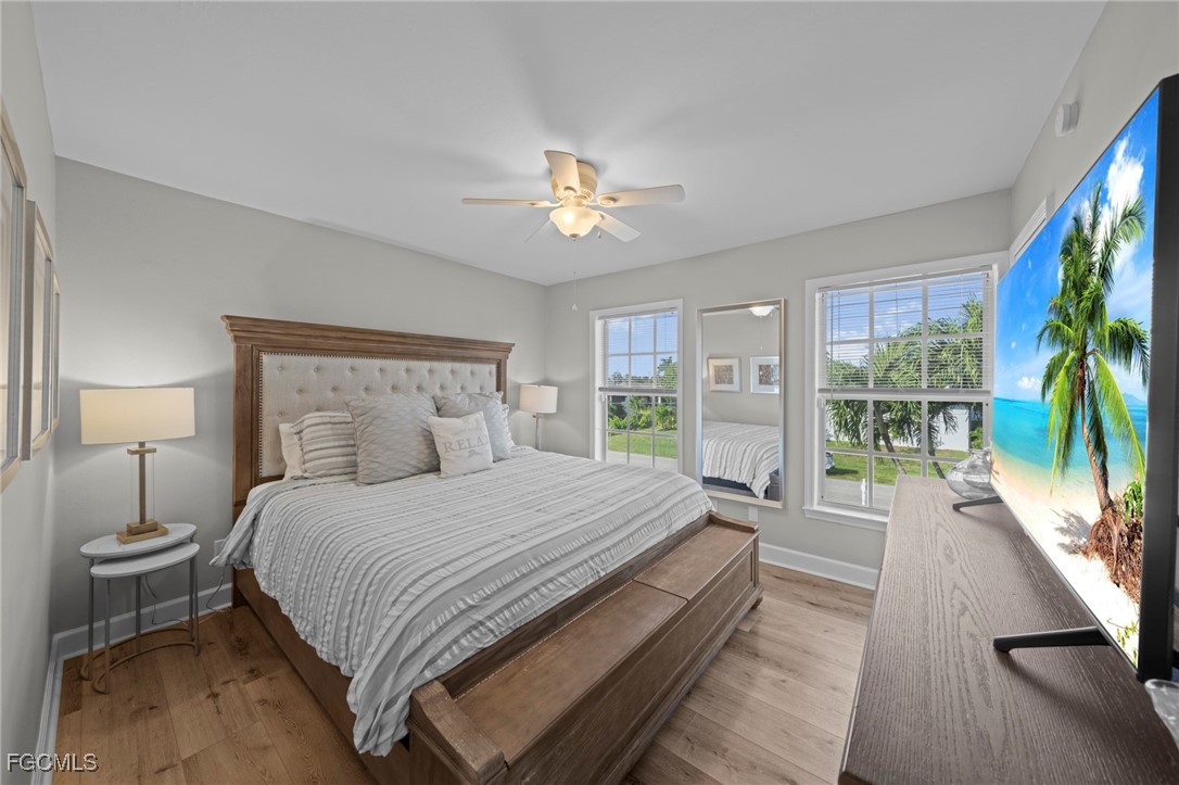 5303 Southwest 26th Court Cape Coral, FL 33914 - Photo 21 of 45 a bedroom with a large bed and a large window