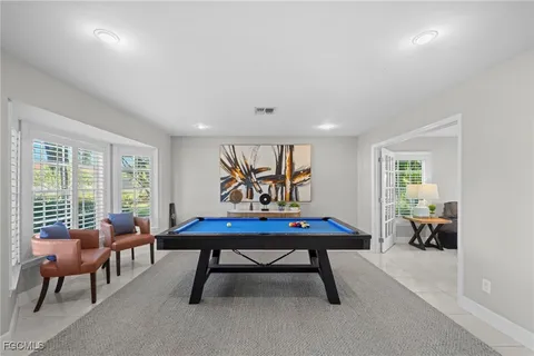a living room with furniture a table and a large window