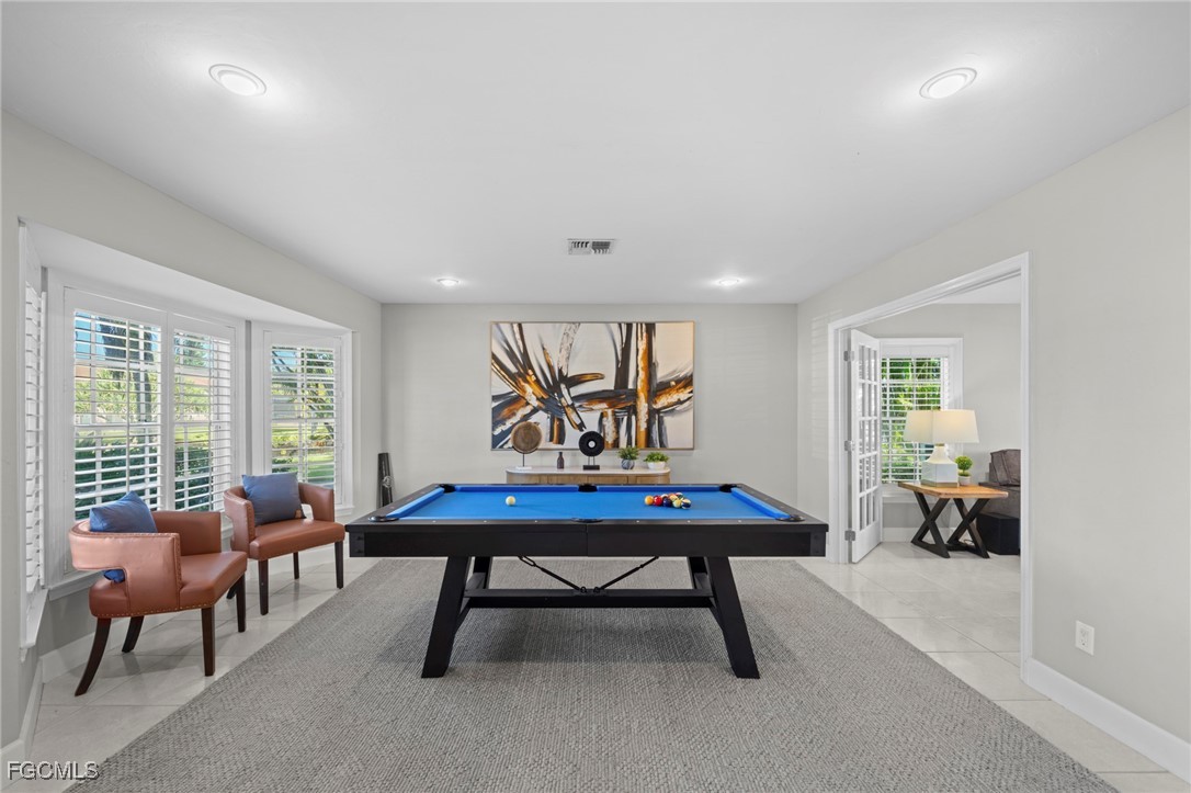 5303 Southwest 26th Court Cape Coral, FL 33914 - Photo 27 of 45 a living room with furniture a table and a large window