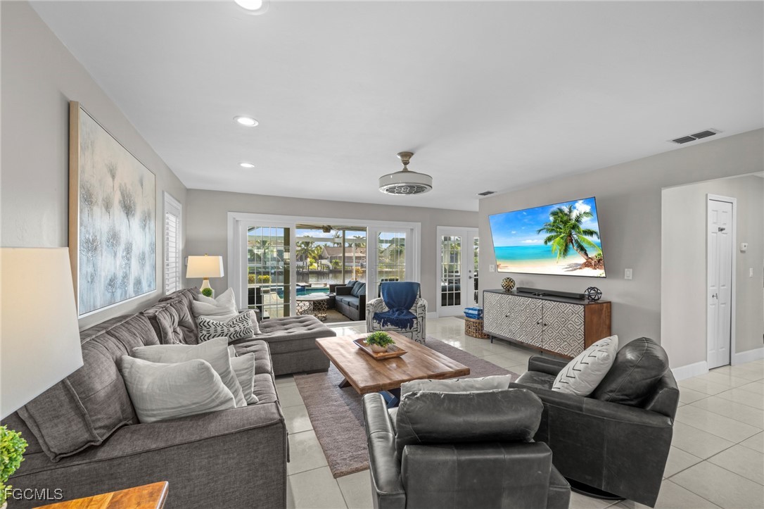 5303 Southwest 26th Court Cape Coral, FL 33914 - Photo 3 of 45 a living room with furniture and a large window