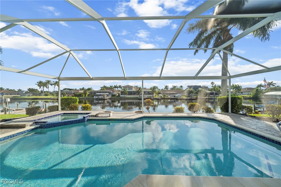 5303 Southwest 26th Court Cape Coral, FL 33914 - Photo 34 of 45 a view of a swimming pool with a porch