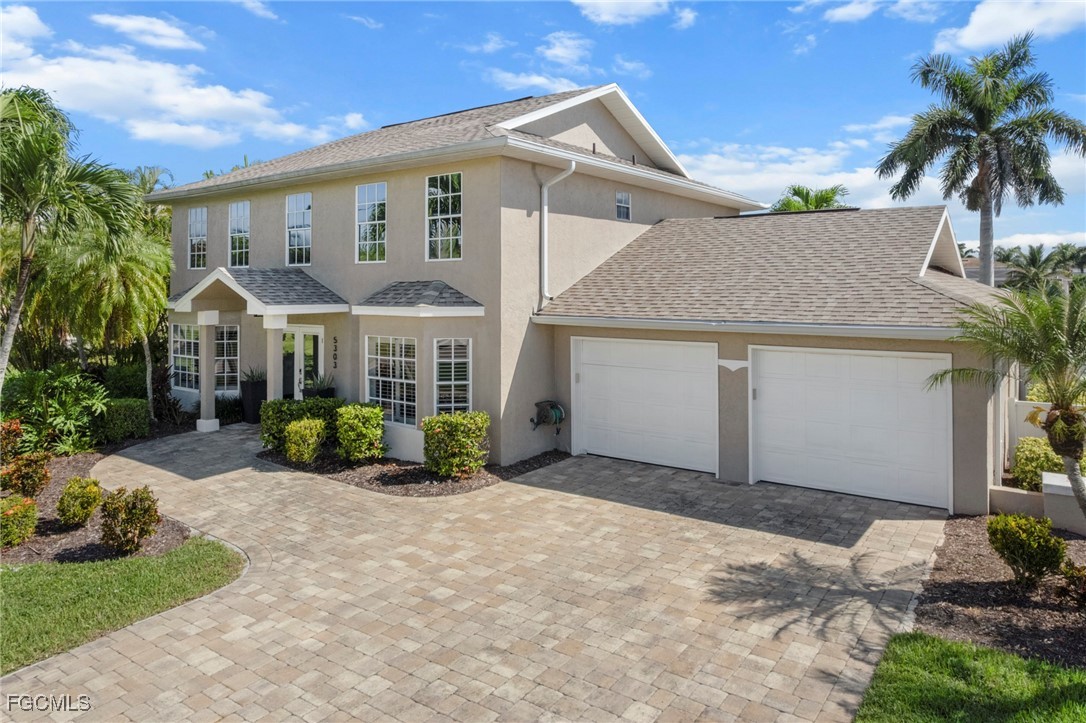 5303 Southwest 26th Court Cape Coral, FL 33914 - Photo 40 of 45 a front view of a house with a yard and potted plants