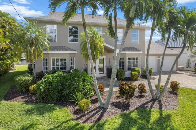 a front view of multiple houses with yard