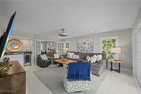 a living room with furniture a rug and a window