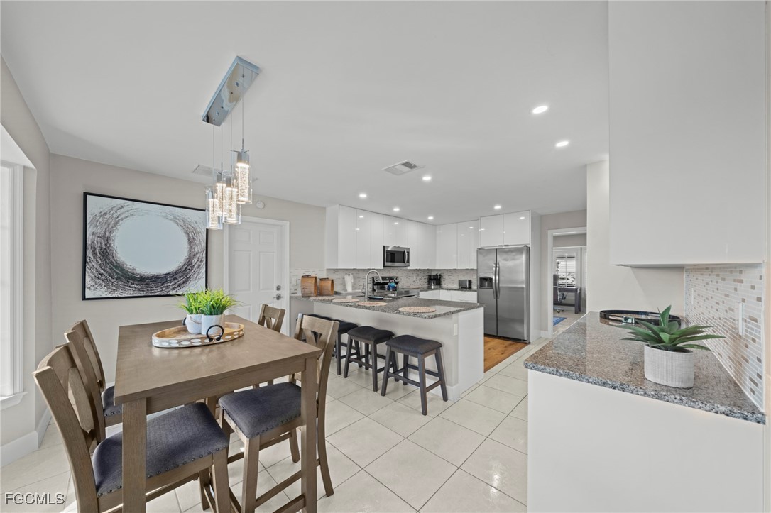 5303 Southwest 26th Court Cape Coral, FL 33914 - Photo 7 of 45 a view of a dining room with furniture