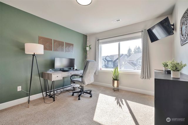a view of a livingroom with workspace and a window