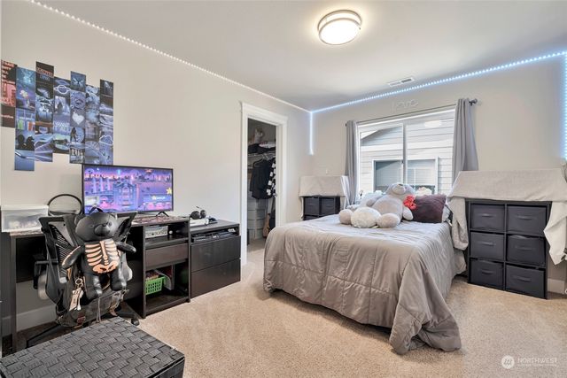 a bedroom with a bed and dresser