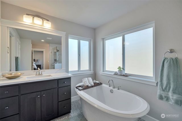 a bathroom with a double vanity sink and a mirror