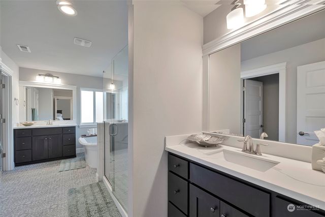 a spacious bathroom with a granite countertop sink mirror and a