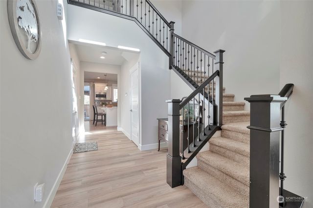 a view of entryway and hall with wooden floor