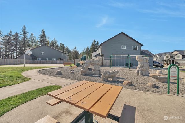 a view of a house with a yard and sitting area