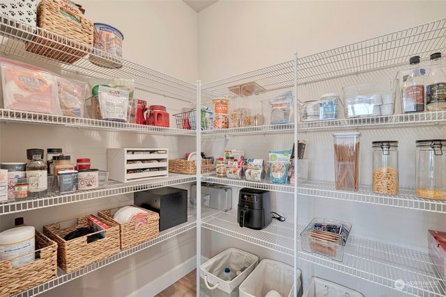 a kitchen with a refrigerator and a stove top oven