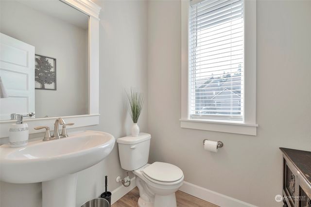 a bathroom with a sink toilet and a mirror